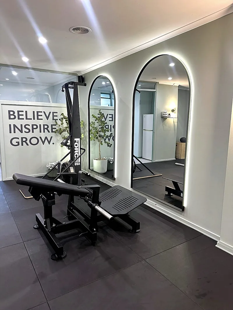 Arched mirrors and the dumbbell rack inside the private Synergy studio, a short drive from Brighton