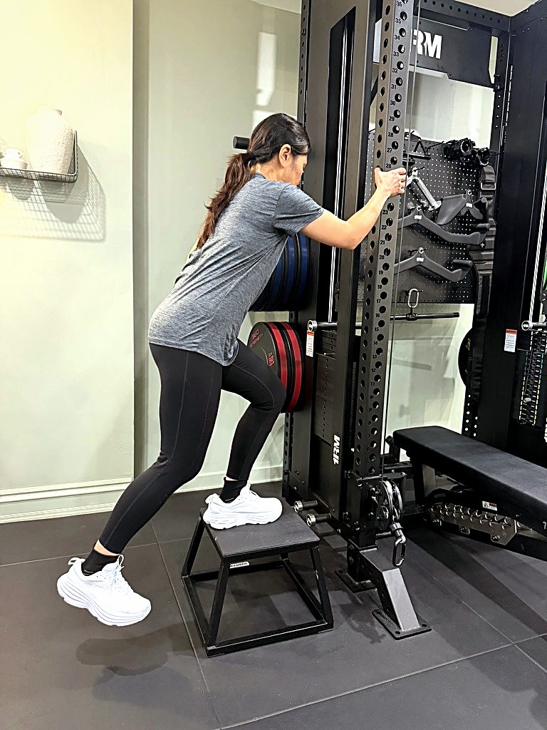 A client working through supported step-ups at the rack in the Synergy studio