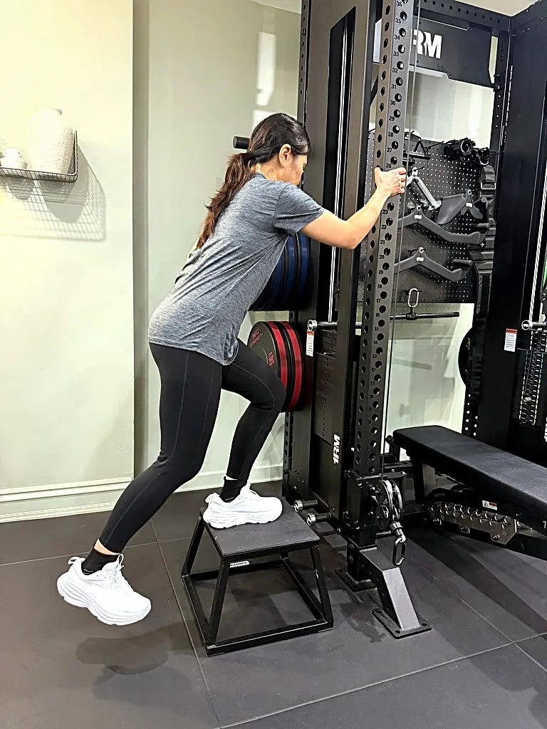A client working through supported step-ups at the rack in the Synergy studio